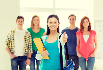 Image showing smiling students with teenage girl in front