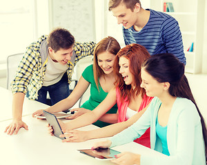 Image showing smiling students with tablet pc at school