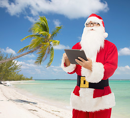 Image showing man in costume of santa claus with tablet pc