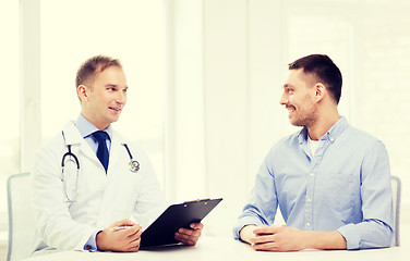 Image showing doctor with clipboard and patient in hospital