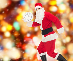 Image showing man in costume of santa claus with clock