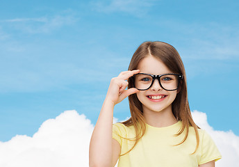 Image showing smiling cute little girl in black eyeglasses