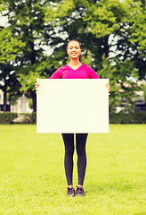 Image showing smiling teenage girl with blank white board