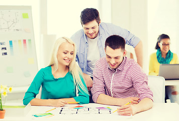 Image showing smiling interior designers working in office