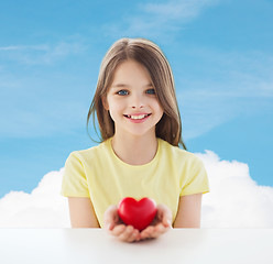 Image showing beautiful little girl sitting at table