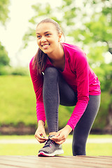 Image showing smiling woman exercising outdoors