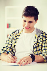 Image showing smiling student with textbooks at school