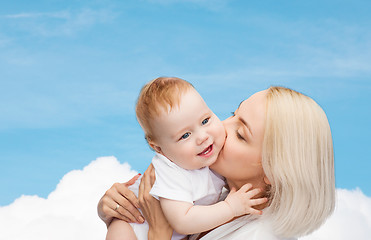 Image showing happy mother kissing smiling baby