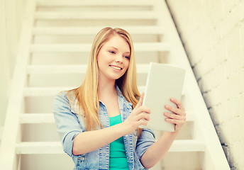 Image showing smiling female student with tablet pc computer