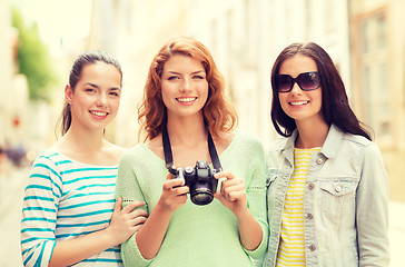 Image showing smiling teenage girls with camera