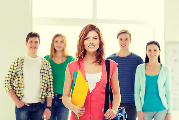 Image showing smiling students with teenage girl in front