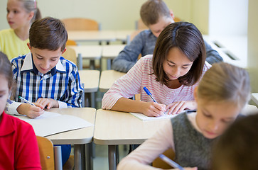 Image showing group of school kids writing test in classroom