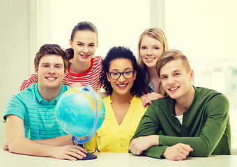 Image showing five smiling student with earth globe at school