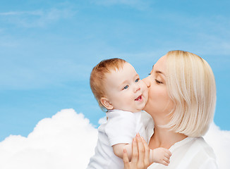 Image showing happy mother kissing smiling baby