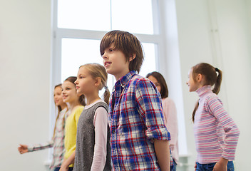 Image showing group of smiling school kids walking in corridor