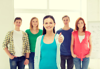 Image showing smiling students with teenage girl in front