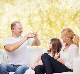 Image showing happy family with camera at home