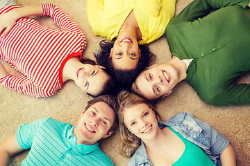 Image showing group of smiling people lying down on floor