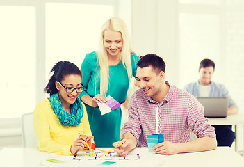 Image showing smiling interior designers working in office