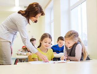 Image showing group of school kids writing test in classroom