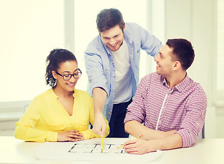 Image showing three smiling architects working in office