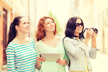 Image showing smiling teenage girls with tablet pc and camera