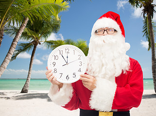 Image showing man in costume of santa claus with clock