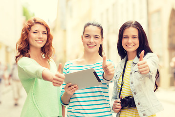 Image showing smiling teenage girls with tablet pc and camera