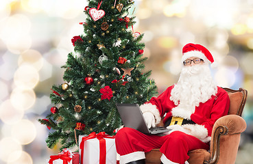 Image showing man in costume of santa claus with laptop