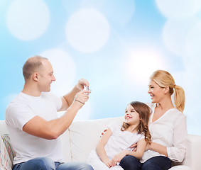 Image showing happy family with camera at home