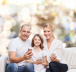 Image showing happy family with smartphones