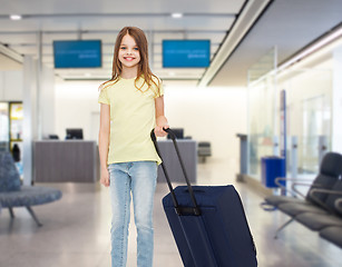 Image showing smiling girl with travel bag in airport