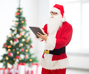 Image showing man in costume of santa claus with tablet pc