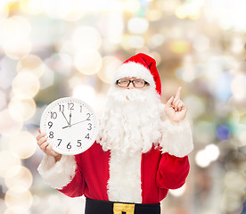 Image showing man in costume of santa claus with clock