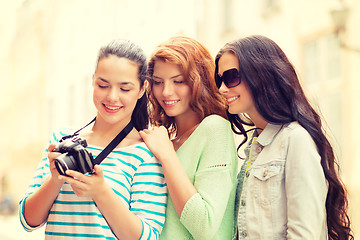 Image showing smiling teenage girls with camera