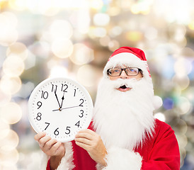 Image showing man in costume of santa claus with clock