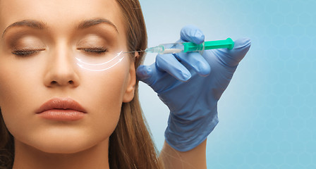 Image showing close up of woman face and hand with syringe