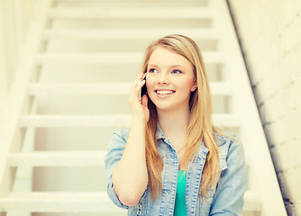 Image showing smiling female student with smartphone