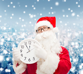 Image showing man in costume of santa claus with clock