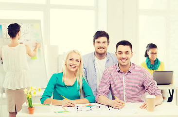 Image showing smiling interior designers working in office