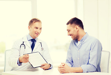 Image showing doctor with clipboard and patient in hospital