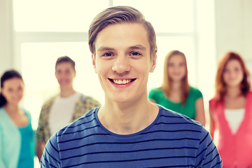 Image showing smiling students with teenage boy in front