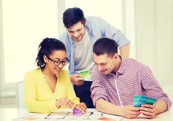 Image showing smiling interior designers working in office