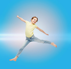 Image showing smiling little girl jumping