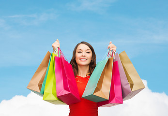 Image showing smiling woman with colorful shopping bags