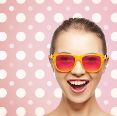 Image showing happy laughing teenage girl in pink shades