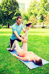 Image showing smiling couple stretching outdoors