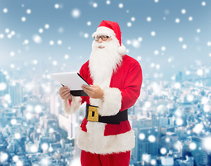 Image showing man in costume of santa claus with notepad