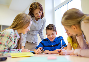 Image showing group of school kids writing test in classroom