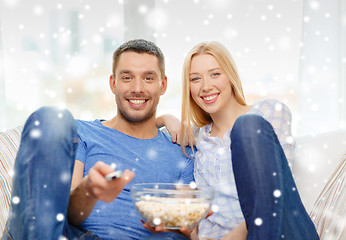 Image showing smiling couple watching tv at home